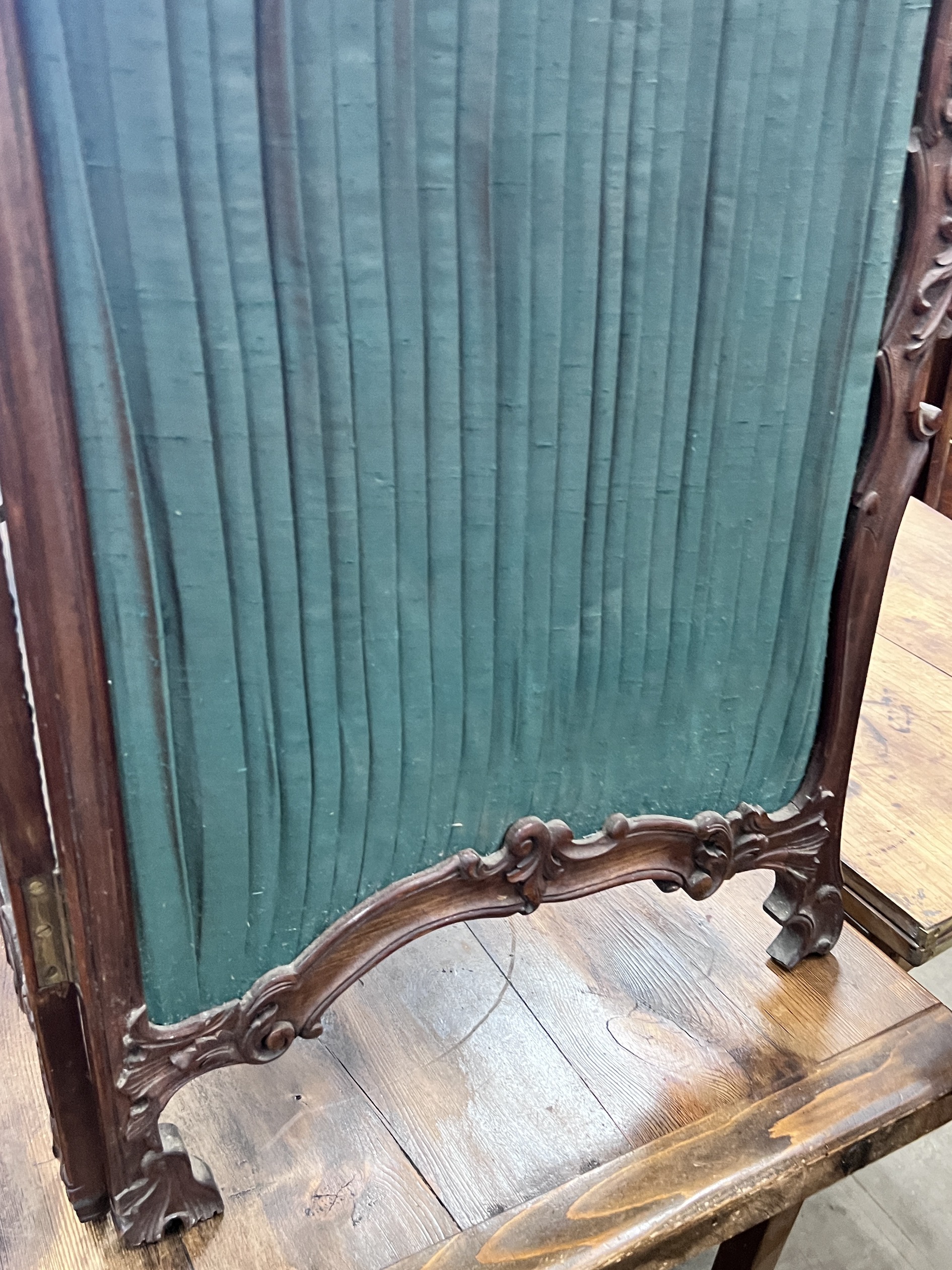 A small Victorian style mahogany two fold carved screen, each panel width 50cm, height 112cm